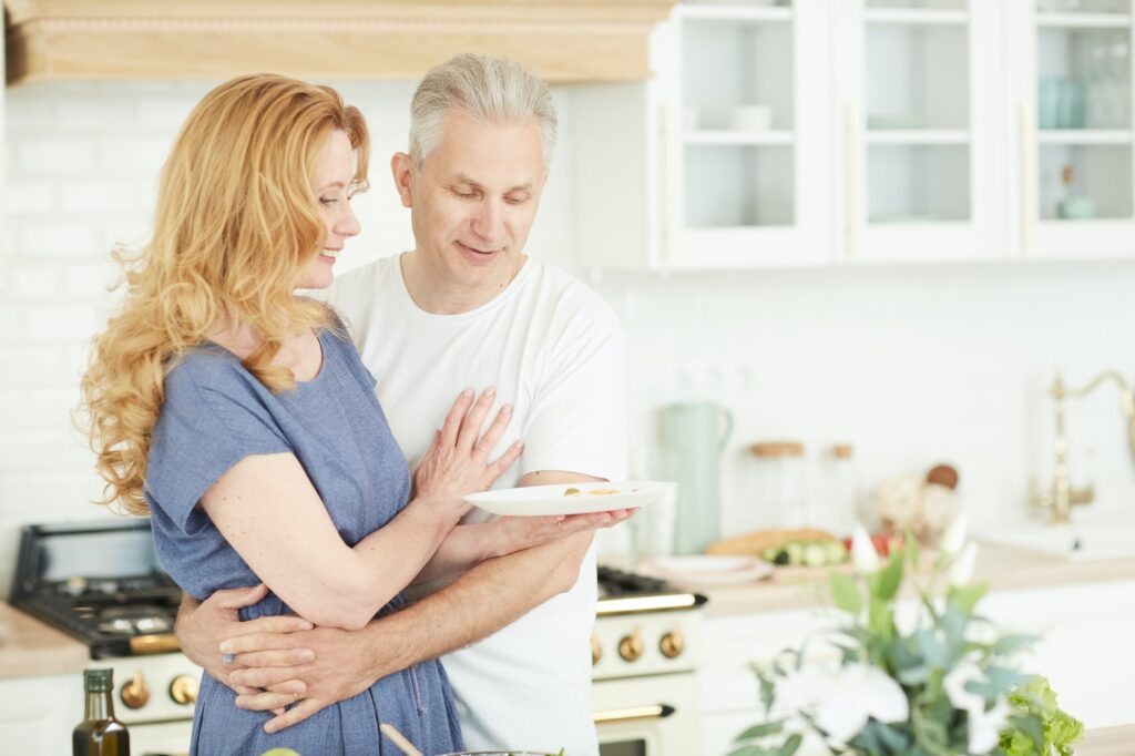 loving mature couple in kitchen