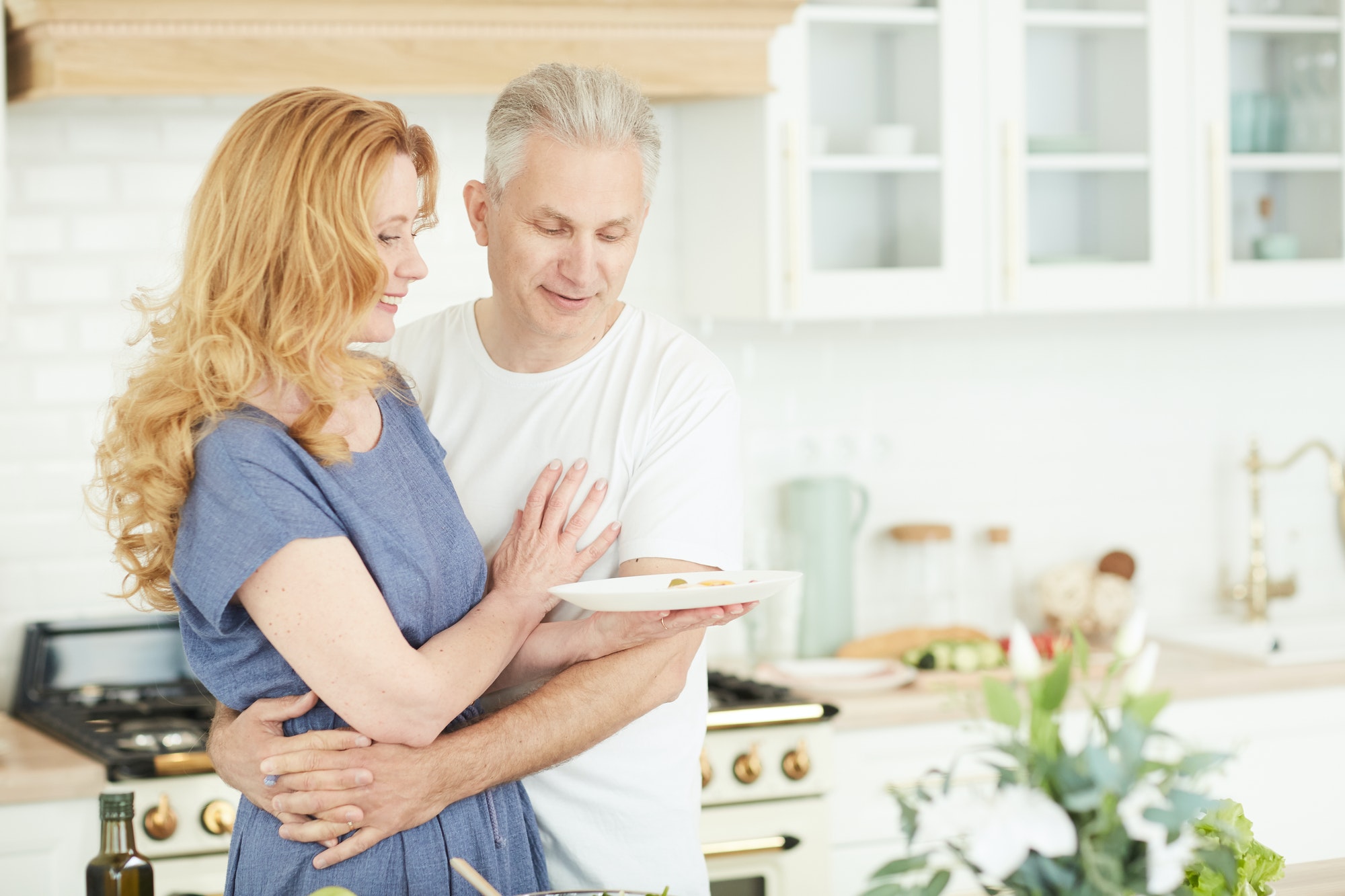 loving mature couple in kitchen