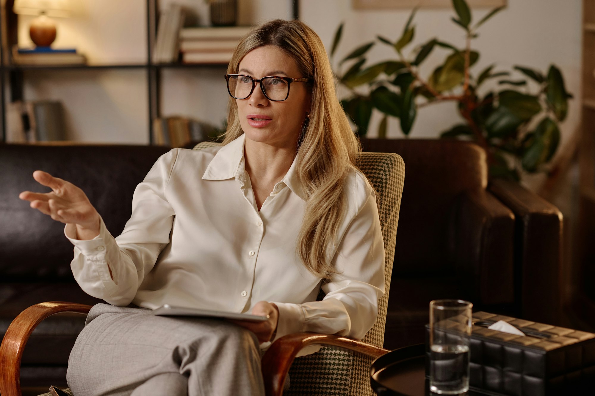 Female Psychologist Sitting at Her Workplace and Speaking